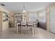 Bright dining area with a stylish table, decorative accents, and natural light from the nearby window at 3840 Cedarwaxwing Ave, Orlando, FL 32822