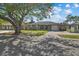 Charming single-story home with a well-maintained lawn and mature tree providing shade at 3840 Cedarwaxwing Ave, Orlando, FL 32822
