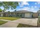 Inviting single-story home with a well-manicured lawn and an attached one-car garage at 3840 Cedarwaxwing Ave, Orlando, FL 32822