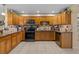 Stylish kitchen featuring wood cabinets, modern appliances, and tiled backsplash at 3840 Cedarwaxwing Ave, Orlando, FL 32822