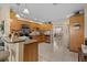 Well-equipped kitchen with wood cabinetry, modern appliances, and granite countertops at 3840 Cedarwaxwing Ave, Orlando, FL 32822