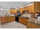 Functional kitchen with wood cabinets, granite countertops, and stainless steel appliances at 3840 Cedarwaxwing Ave, Orlando, FL 32822
