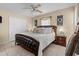 Cozy main bedroom with a decorative headboard, plush bedding, ceiling fan, and a window at 3840 Cedarwaxwing Ave, Orlando, FL 32822