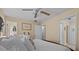 Comfortable main bedroom with plush bedding, ceiling fan, and natural light at 3840 Cedarwaxwing Ave, Orlando, FL 32822
