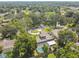 Aerial view of a home in a lush neighborhood with tree-lined streets and community amenities at 4174 Fallwood Cir, Orlando, FL 32812