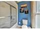 This bathroom features a shower-tub, a toilet, and a bright blue painted wall at 4174 Fallwood Cir, Orlando, FL 32812