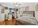 Inviting bedroom with hardwood floors, bed, and a well-organized workspace area at 4174 Fallwood Cir, Orlando, FL 32812