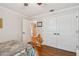 Bright bedroom showcasing closet and view to hall with contrasting flooring at 4174 Fallwood Cir, Orlando, FL 32812