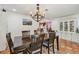 Elegant dining room with modern chandelier, seating for six and built in cabinet at 4174 Fallwood Cir, Orlando, FL 32812
