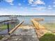 Lakefront home featuring a private dock with ramp and gazebo, offering serene waterfront living and recreational opportunities at 4174 Fallwood Cir, Orlando, FL 32812