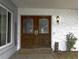 Inviting front entrance featuring double wooden doors and decorative stone accents at 4174 Fallwood Cir, Orlando, FL 32812