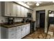 Open kitchen with stainless appliances, granite countertops and white cabinetry at 4174 Fallwood Cir, Orlando, FL 32812