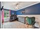 The home office with accent wall, carpet and white wainscotting features a sewing station and dual monitors at 4174 Fallwood Cir, Orlando, FL 32812
