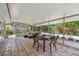 Charming covered patio featuring tiled flooring, an outdoor dining set, and serene garden views at 4174 Fallwood Cir, Orlando, FL 32812