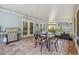Relaxing covered patio with a grill, dining set, and comfortable seating, perfect for outdoor living at 4174 Fallwood Cir, Orlando, FL 32812