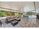 Inviting covered patio with comfortable seating, dining area, and a view of the sparkling pool at 4174 Fallwood Cir, Orlando, FL 32812