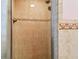 Tiled shower with decorative trim, perfect for a luxurious bathroom experience at 4174 Fallwood Cir, Orlando, FL 32812