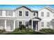 Charming two-story townhome with gray siding, manicured lawn, and colorful flower beds enhancing curb appeal at 4200 Sadler Rd, Apopka, FL 32712