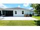 Enjoy this backyard with a spacious patio, lawn, and stylish home exterior at 4687 Fairy Tale Cir, Kissimmee, FL 34746