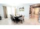 Elegant dining room with modern lighting, a stylish wine rack, and space for entertaining at 4687 Fairy Tale Cir, Kissimmee, FL 34746