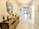 A stylish entryway with tile flooring, modern furniture, and elegant decorative touches at 4687 Fairy Tale Cir, Kissimmee, FL 34746