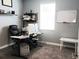 A well-lit home office with a large desk, comfortable chair, and a whiteboard at 4687 Fairy Tale Cir, Kissimmee, FL 34746