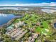 Stunning aerial view of a golf course community with lush fairways, sparkling lakes, and luxury homes at 5067 Latrobe Dr, Windermere, FL 34786