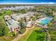 Gorgeous aerial view of a resort featuring multiple pools, golf course, lush grounds, and stunning waterfront scenery at 5067 Latrobe Dr, Windermere, FL 34786