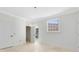 Bedroom with travertine floors, multiple doors, and a window overlooking the yard at 5067 Latrobe Dr, Windermere, FL 34786