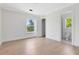 Bright bedroom featuring hardwood floors, white walls, and a window overlooking the yard at 5067 Latrobe Dr, Windermere, FL 34786