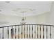 Interior view featuring iron railing and a decorative chandelier hanging from a recessed ceiling at 5067 Latrobe Dr, Windermere, FL 34786