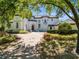 Elegant two-story home featuring a brick driveway, manicured landscaping, and a stately entrance at 5067 Latrobe Dr, Windermere, FL 34786