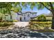 Elegant two-story home featuring a brick driveway, manicured landscaping, and a stately entrance at 5067 Latrobe Dr, Windermere, FL 34786