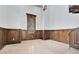 Spacious room featuring wood paneling, beige tile flooring, a large window, and views of the property's exterior at 5067 Latrobe Dr, Windermere, FL 34786