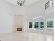 Bright living area featuring fireplace, high ceilings, marble floors, and views of the outdoors at 5067 Latrobe Dr, Windermere, FL 34786