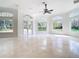 Open living room with many windows, tile floors, and glass doors to the exterior at 5067 Latrobe Dr, Windermere, FL 34786