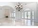 Living room with tiled floor, fireplace, white pillars, and glass doors at 5067 Latrobe Dr, Windermere, FL 34786