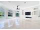 Spacious living room with large windows, custom built-ins, and tiled floors at 5067 Latrobe Dr, Windermere, FL 34786