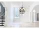 Bright living room featuring tile floors, stairs, large windows, and ornate lighting at 5067 Latrobe Dr, Windermere, FL 34786