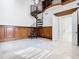 Spacious living room features marble floors, spiral staircase, wood paneling, chandelier, and access to a second story library at 5067 Latrobe Dr, Windermere, FL 34786