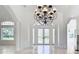 Living room with tiled floor, white pillars and trim, and glass doors at 5067 Latrobe Dr, Windermere, FL 34786
