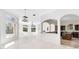 Bright, open living room featuring large windows and views of lush landscaping at 5067 Latrobe Dr, Windermere, FL 34786