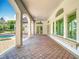 Expansive outdoor patio with brick pavers, arched columns, and views of the pool and backyard at 5067 Latrobe Dr, Windermere, FL 34786