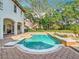 Inviting pool with unique design, surrounded by brick pavers and lush landscaping, perfect for relaxation and entertainment at 5067 Latrobe Dr, Windermere, FL 34786