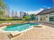 View of pool, patio and landscaped backyard with trees and manicured hedges at 5067 Latrobe Dr, Windermere, FL 34786