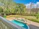View from the balcony of the in-ground pool, large yard with mature trees, trimmed hedges and lush lawn at 5067 Latrobe Dr, Windermere, FL 34786