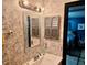Compact bathroom with vintage wallpaper, decorative mirror and vanity, adjacent bedroom entry at 527 Leland Dr, Deltona, FL 32725