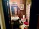 Compact bathroom featuring sink vanity and toilet. Note the dark wood panels on the wall at 527 Leland Dr, Deltona, FL 32725