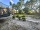 Residential backyard featuring sparse landscaping, with a trampoline and basketball hoop in view at 5298 Rose Ave, Orlando, FL 32810