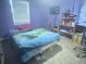 Bedroom features large window, purple walls, and a queen sized bed at 5298 Rose Ave, Orlando, FL 32810